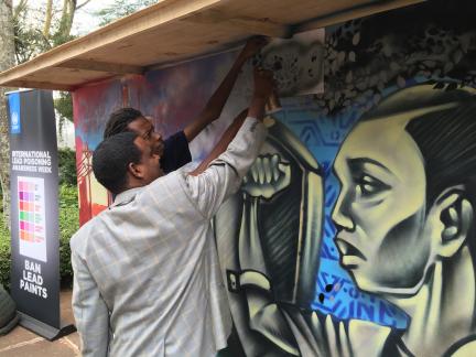 Tadesse Amera painting the mural at UNEA2